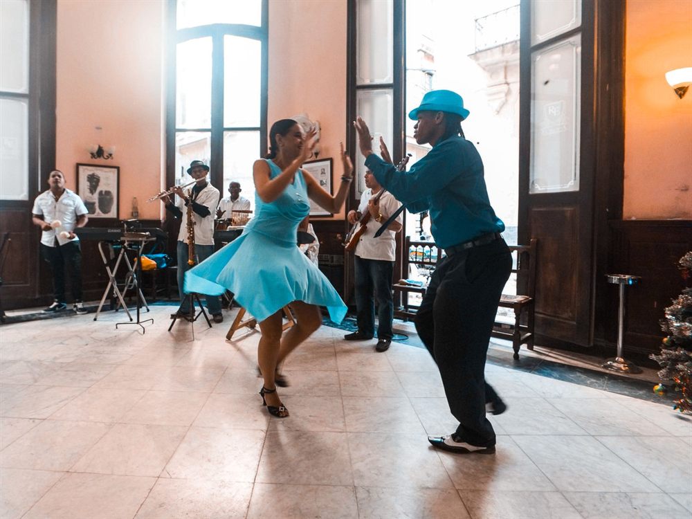 Couple dancing to a live band in a Latin American cafe